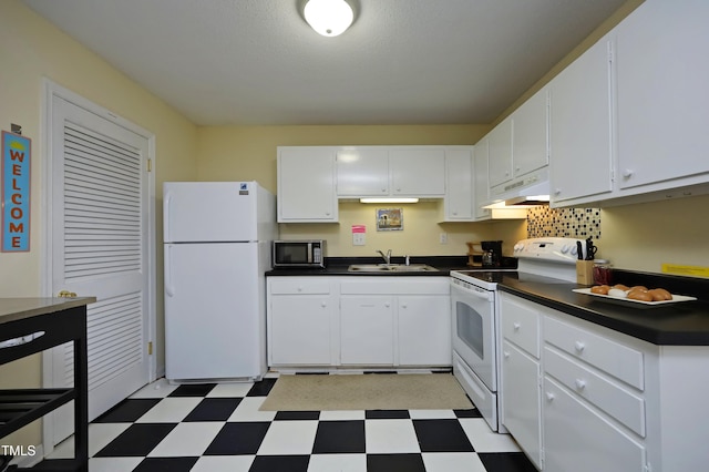 kitchen with white appliances, sink, a textured ceiling, and white cabinetry