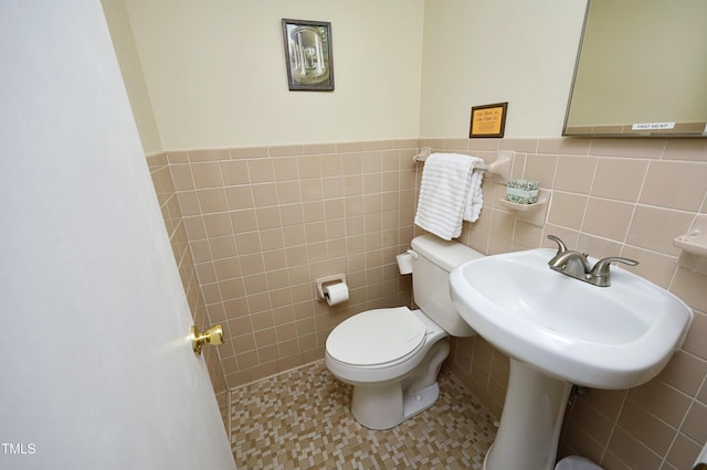 bathroom with tile walls, tile patterned flooring, and toilet