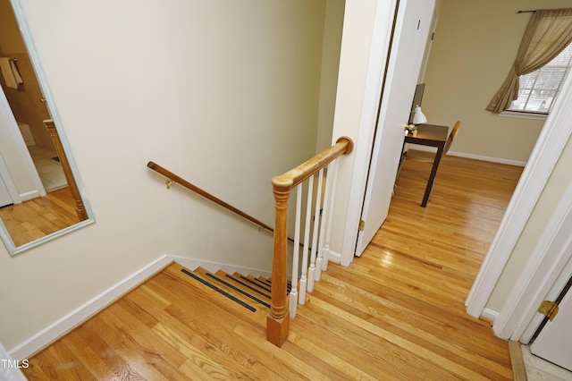 stairs featuring hardwood / wood-style floors