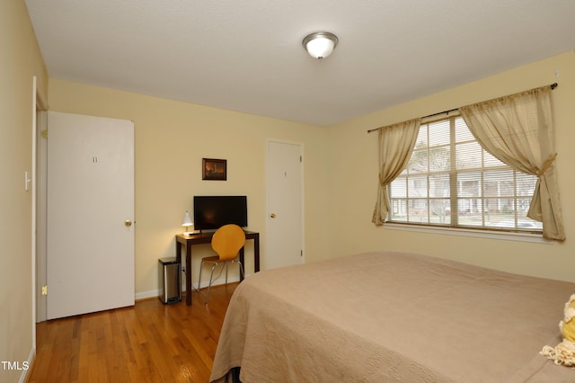 bedroom with hardwood / wood-style floors