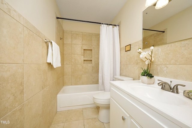 full bathroom featuring tile patterned flooring, tile walls, toilet, shower / bath combo with shower curtain, and vanity