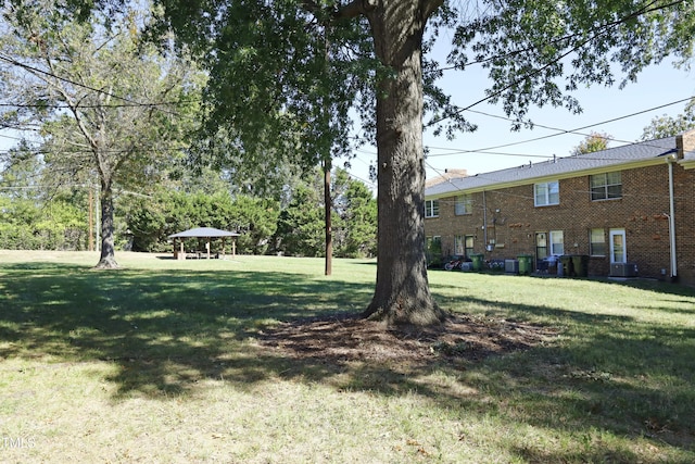 view of yard with central AC unit and a gazebo