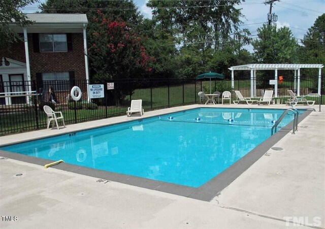 view of pool featuring a patio area and a pergola