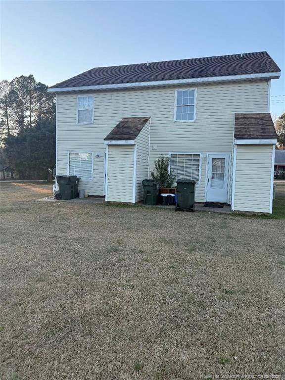 back of house with a yard