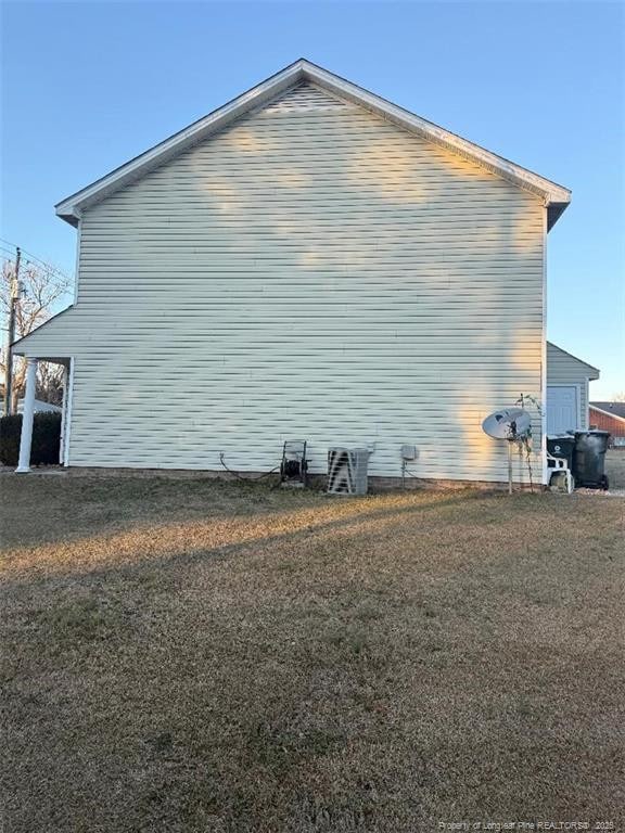 view of side of property with a yard