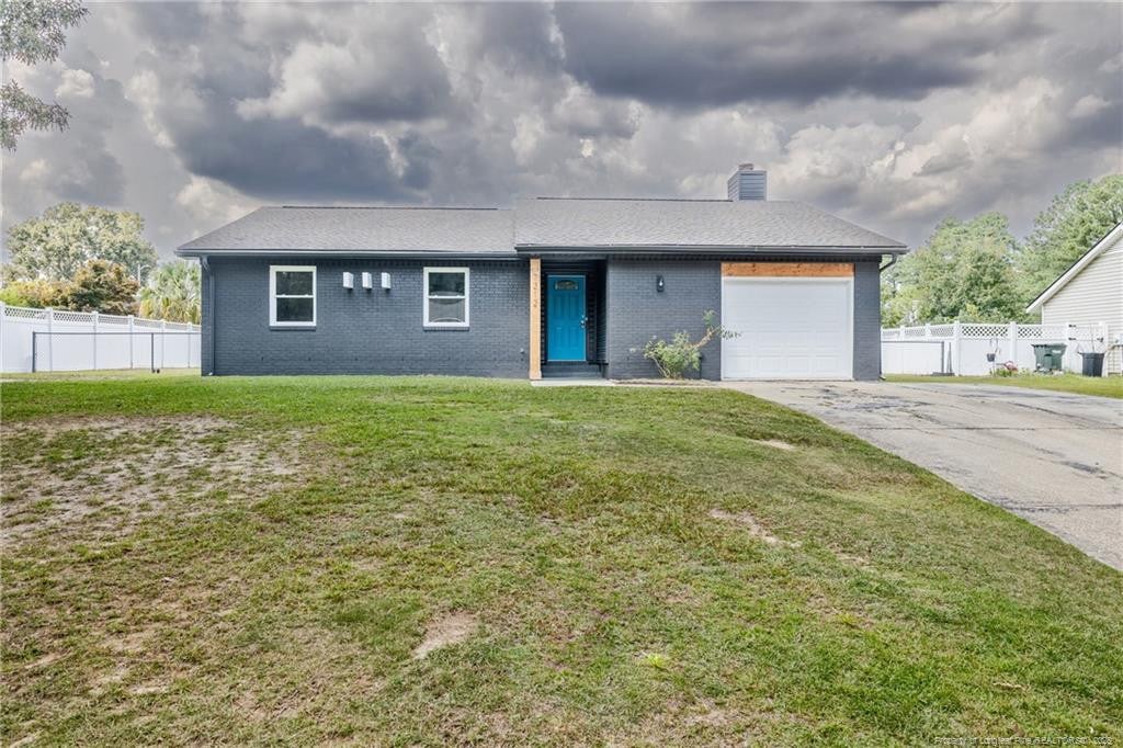 view of front of house with a front yard and a garage