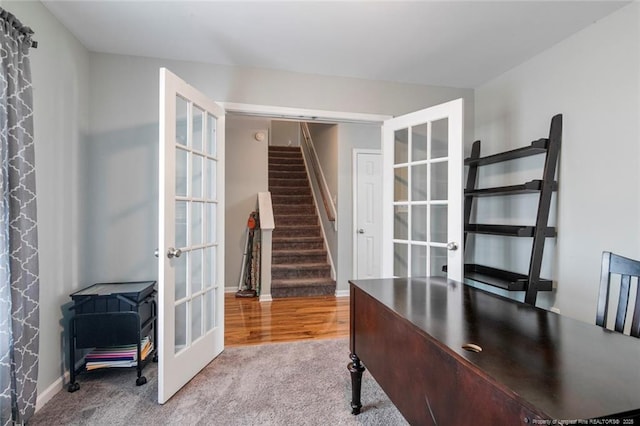 carpeted home office featuring baseboards and french doors