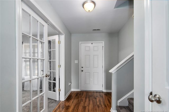 foyer featuring wood finished floors, visible vents, baseboards, stairs, and french doors