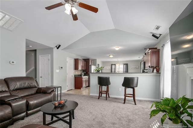 living room featuring lofted ceiling, light colored carpet, a ceiling fan, baseboards, and visible vents