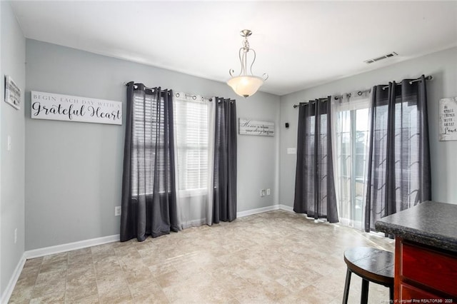 unfurnished dining area featuring visible vents and baseboards