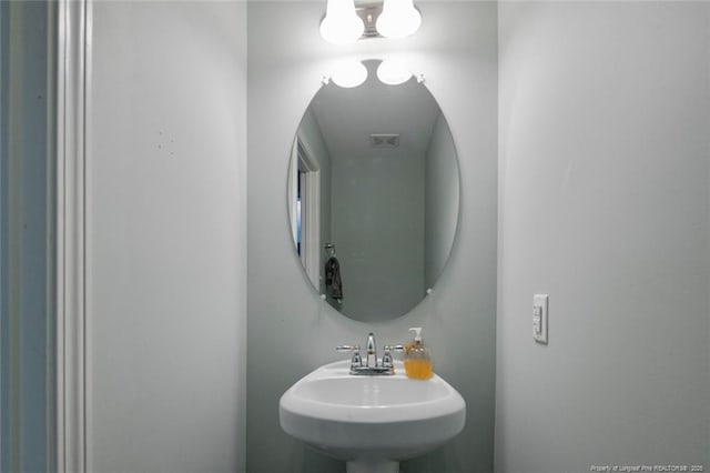 bathroom featuring visible vents and a sink