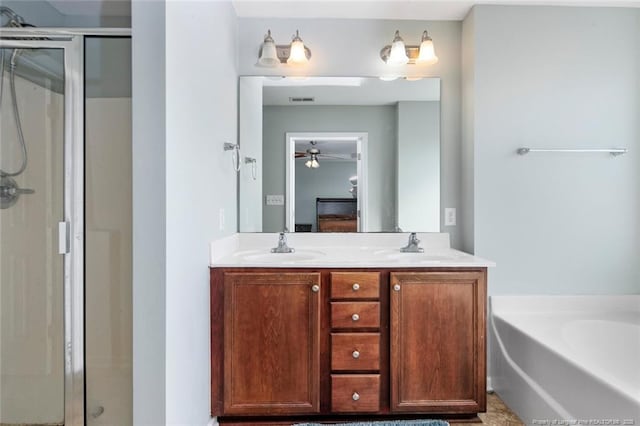 bathroom featuring double vanity, a shower stall, a sink, and a bath