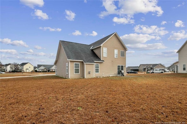 rear view of property with a lawn