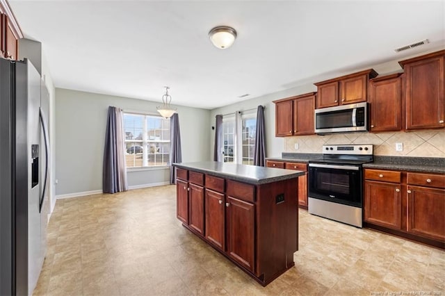 kitchen with dark countertops, visible vents, stainless steel appliances, and decorative backsplash