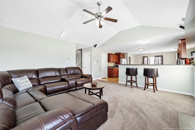 living room with a ceiling fan, baseboards, visible vents, vaulted ceiling, and light colored carpet