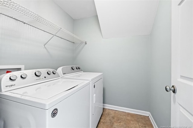 clothes washing area featuring laundry area, independent washer and dryer, and baseboards