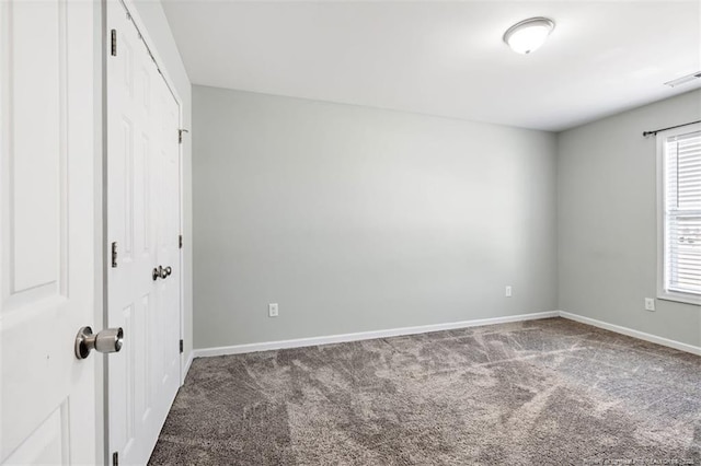 unfurnished bedroom with baseboards, visible vents, and carpet floors