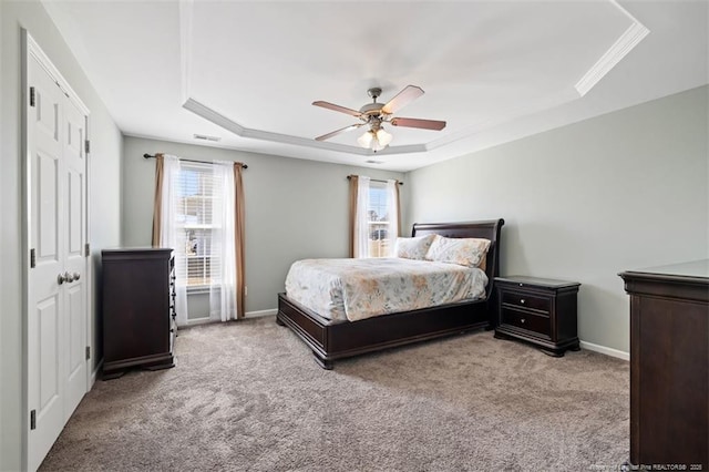 bedroom with baseboards, a raised ceiling, a ceiling fan, and carpet flooring