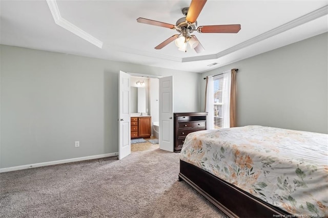 bedroom featuring visible vents, baseboards, a tray ceiling, light carpet, and connected bathroom