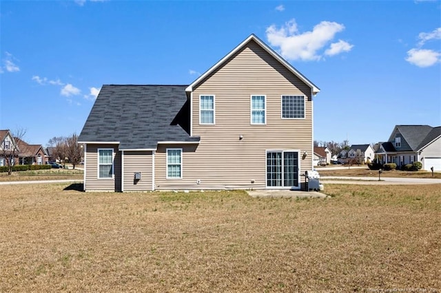 rear view of house with a lawn