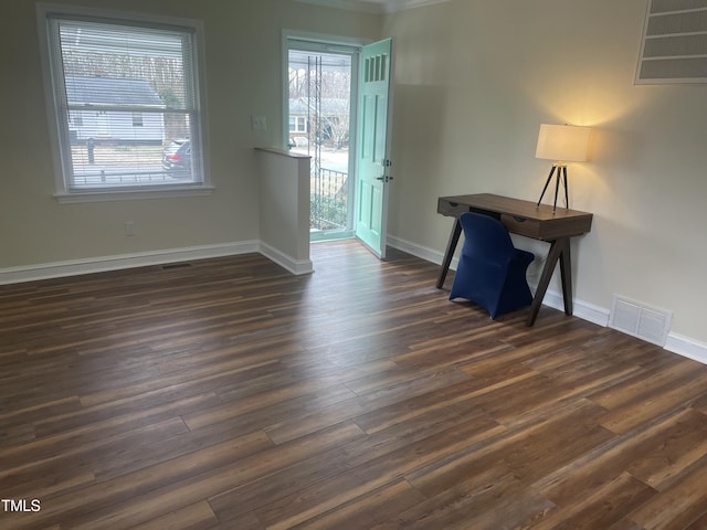 interior space with dark wood-type flooring and ornamental molding