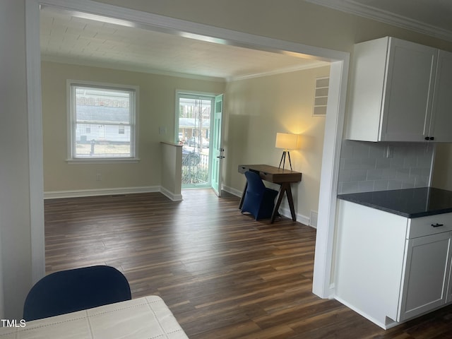 living room featuring dark wood-type flooring and crown molding