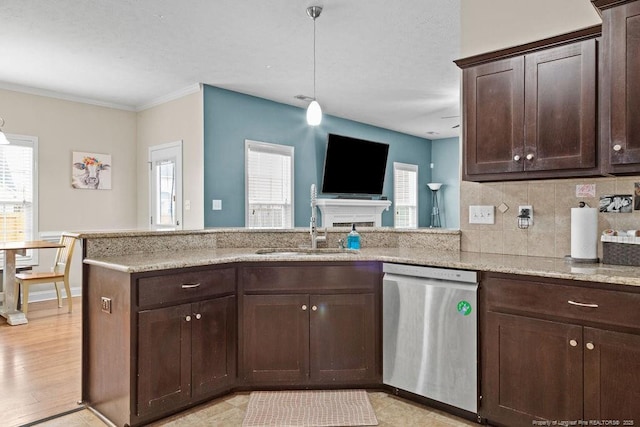 kitchen featuring sink, a healthy amount of sunlight, stainless steel dishwasher, kitchen peninsula, and dark brown cabinets