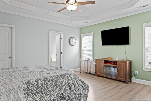 bedroom featuring a raised ceiling, ceiling fan, light hardwood / wood-style flooring, and ornamental molding