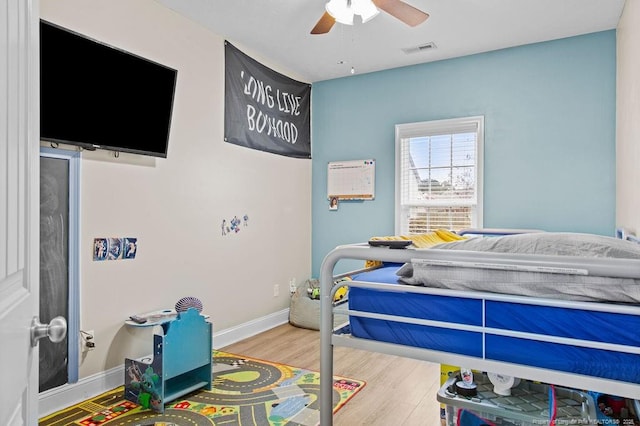 bedroom with hardwood / wood-style flooring and ceiling fan