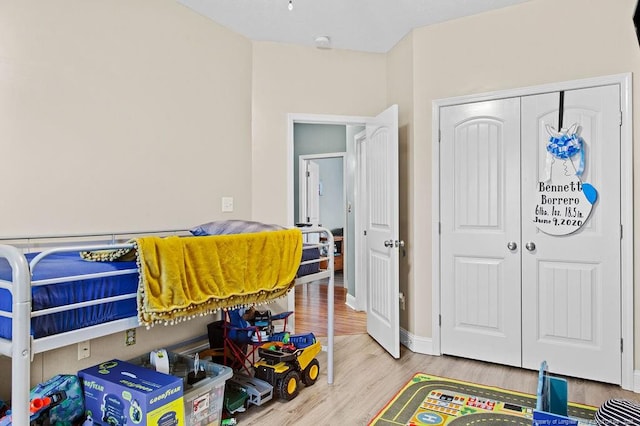 bedroom with a closet and hardwood / wood-style flooring