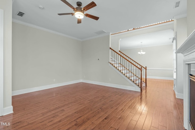 unfurnished living room with ceiling fan with notable chandelier, light hardwood / wood-style flooring, and crown molding