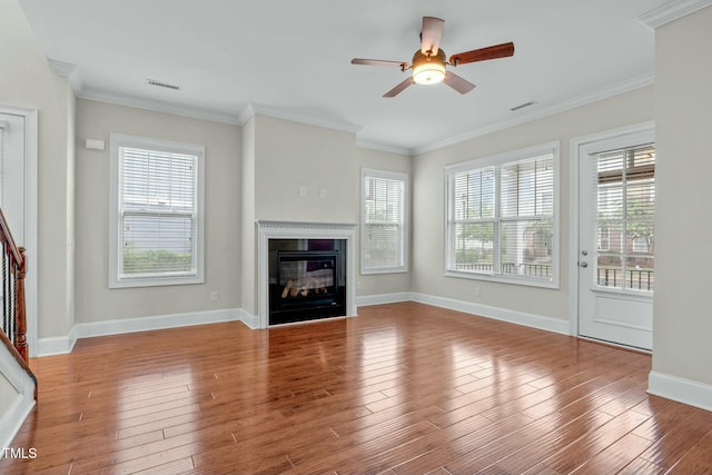 unfurnished living room with light hardwood / wood-style flooring, plenty of natural light, crown molding, and ceiling fan