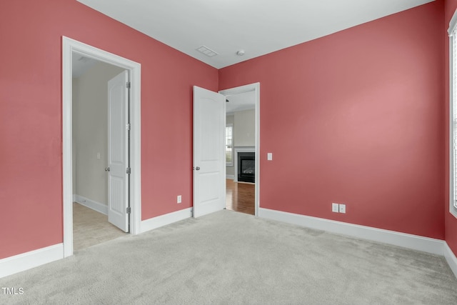 unfurnished bedroom featuring light colored carpet