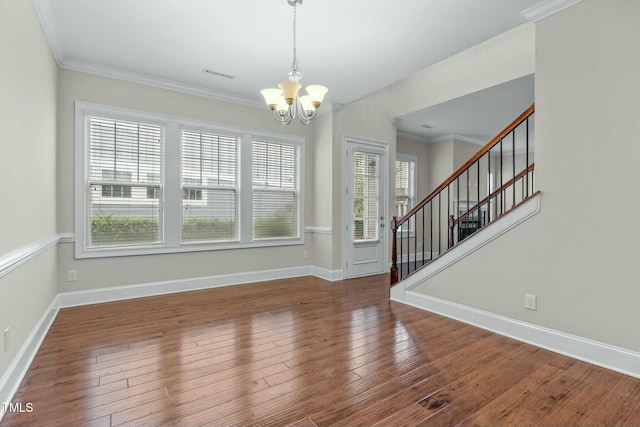 interior space with crown molding, a chandelier, and hardwood / wood-style flooring