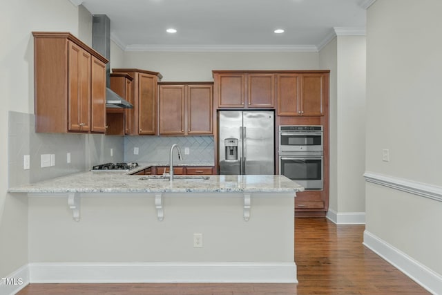 kitchen with sink, stainless steel appliances, a kitchen breakfast bar, kitchen peninsula, and ornamental molding