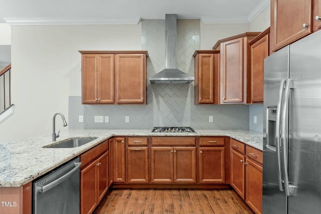 kitchen with crown molding, sink, wall chimney exhaust hood, decorative backsplash, and appliances with stainless steel finishes