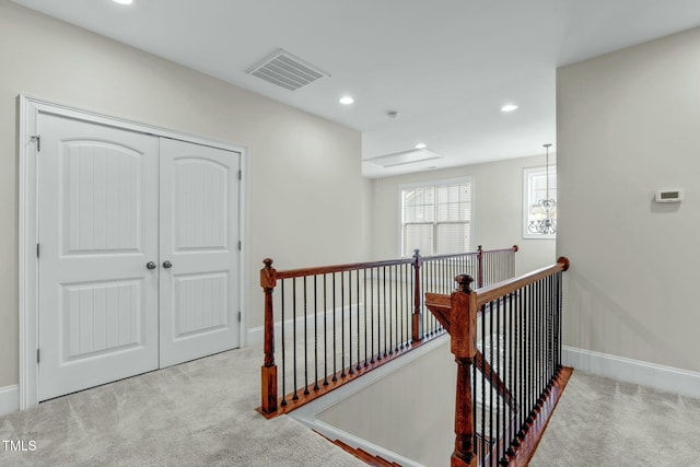 corridor with light colored carpet