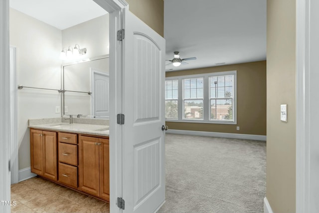 bathroom featuring ceiling fan and vanity