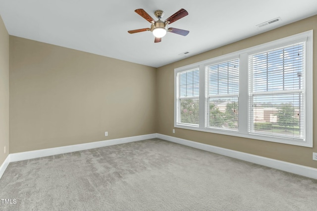 spare room with light carpet and ceiling fan