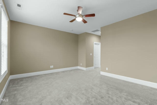 unfurnished room with light colored carpet and ceiling fan