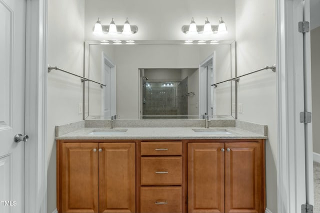 bathroom featuring a shower with door and vanity