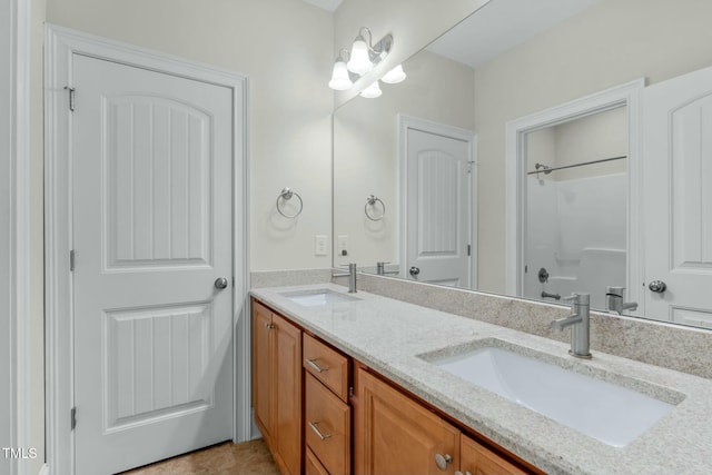 bathroom with tile patterned floors, vanity, and a shower