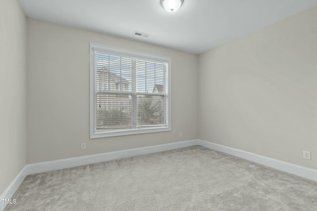 unfurnished room featuring light carpet