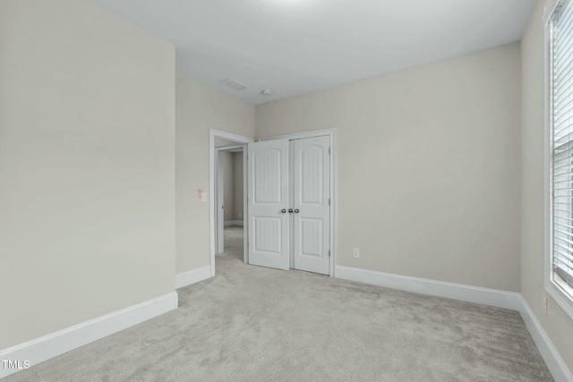 unfurnished bedroom featuring light colored carpet