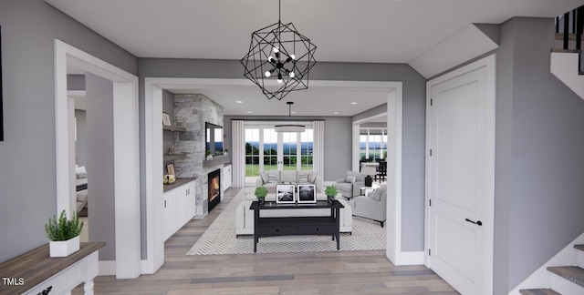 interior space featuring light hardwood / wood-style floors and a notable chandelier