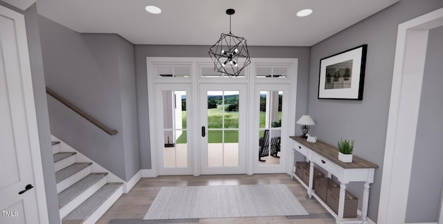 foyer with a chandelier and light wood-type flooring