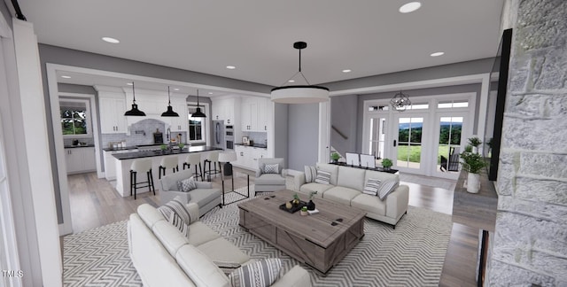 living room with light wood-type flooring, french doors, and a chandelier