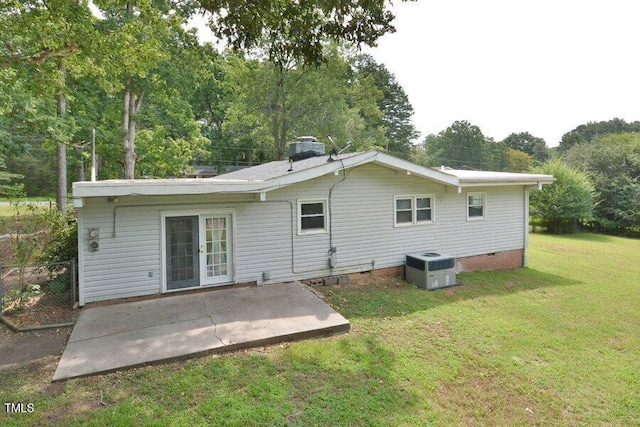 back of property with central AC, a yard, a patio, and french doors