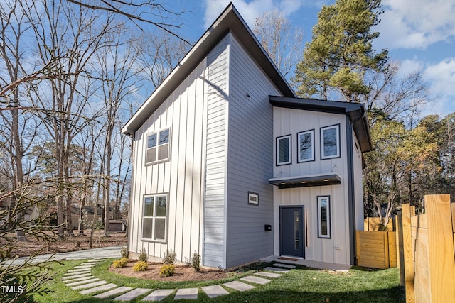 rear view of property featuring a yard