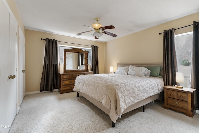 bedroom with ceiling fan and a closet